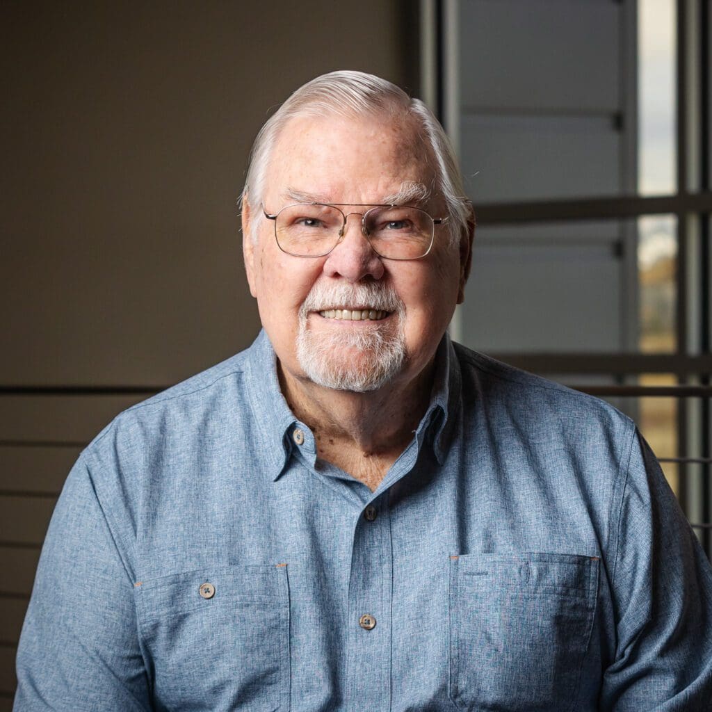 An older man wearing glasses and a blue shirt representing Fann Contracting.