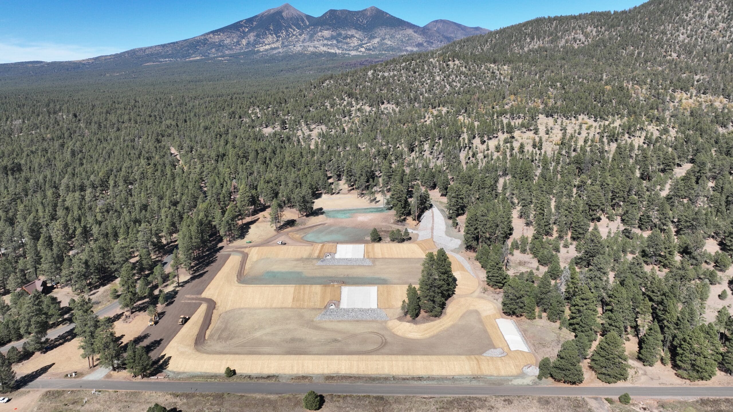 An aerial view of a construction site in a forest.