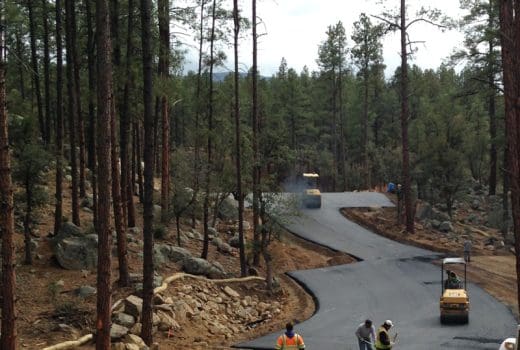 A group of people are working on the Goldwater Lake Park Day Use Expansion Project in the woods.