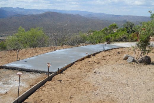 A concrete walkway is being built on the side of a mountain at Sunset Point Rest Area on I-17.