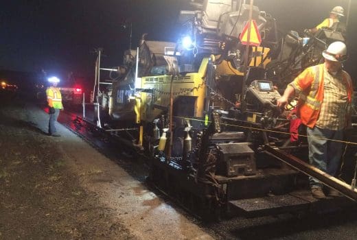 Two men working on a machine at Phoenix-Cordes Junction Hwy.